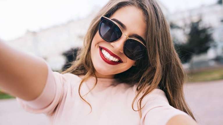 woman smiling after getting some cosmetic dental services at North Idaho Dental Group