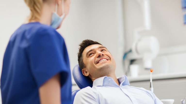 man smiling after getting dental implants in coeur d'alene