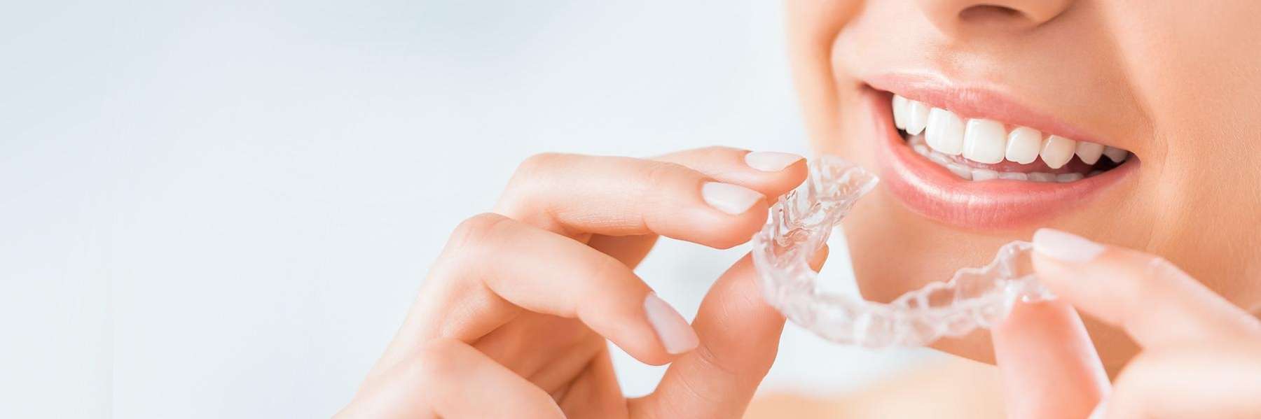 woman using Invisalign clear aligners in coeur d'alene