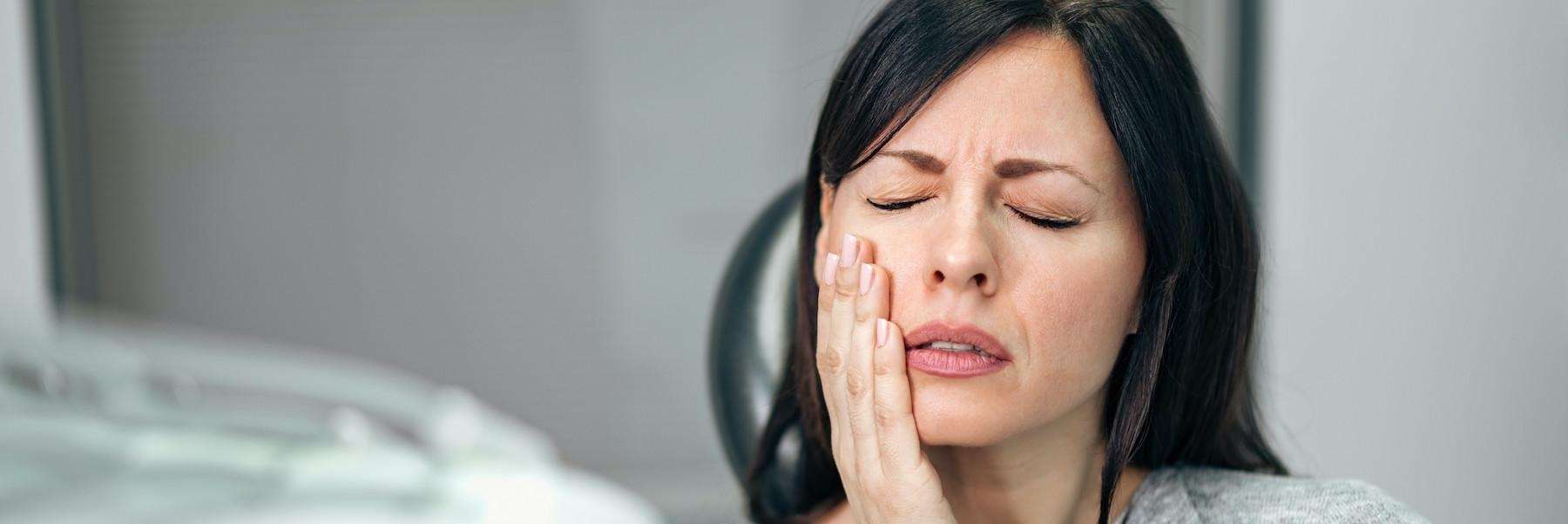 woman holding jaw from bruxism pain in sandpoint