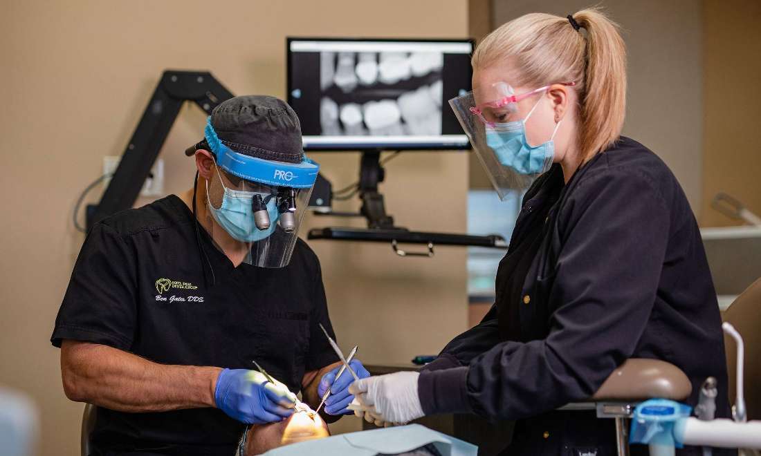 Dr. Ben Gates and hygienist working on patient