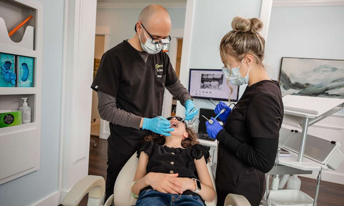 Dr. Mickelson Cleans a Young Patient's Teeth in ponderay