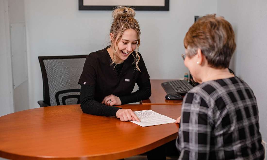 Staff member discussing treatment plan with client in ponderay